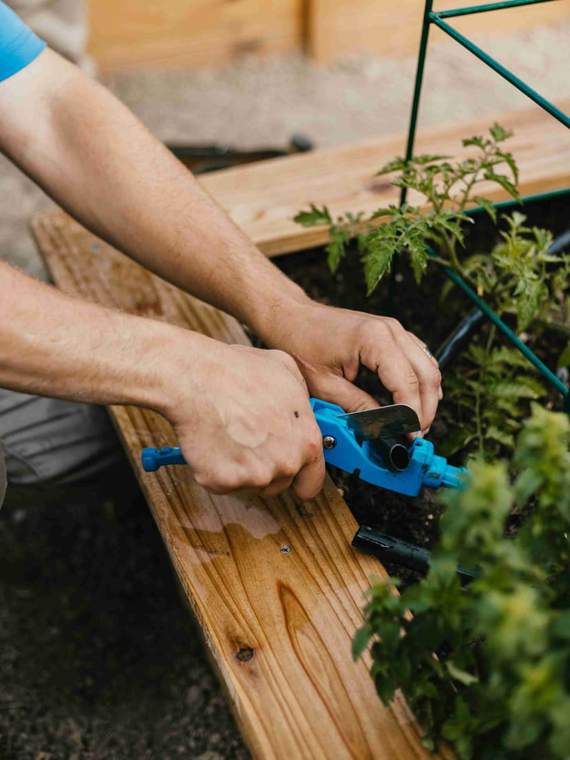Storm Sprinklers repairing drip irrigation leak in Utah garden bed