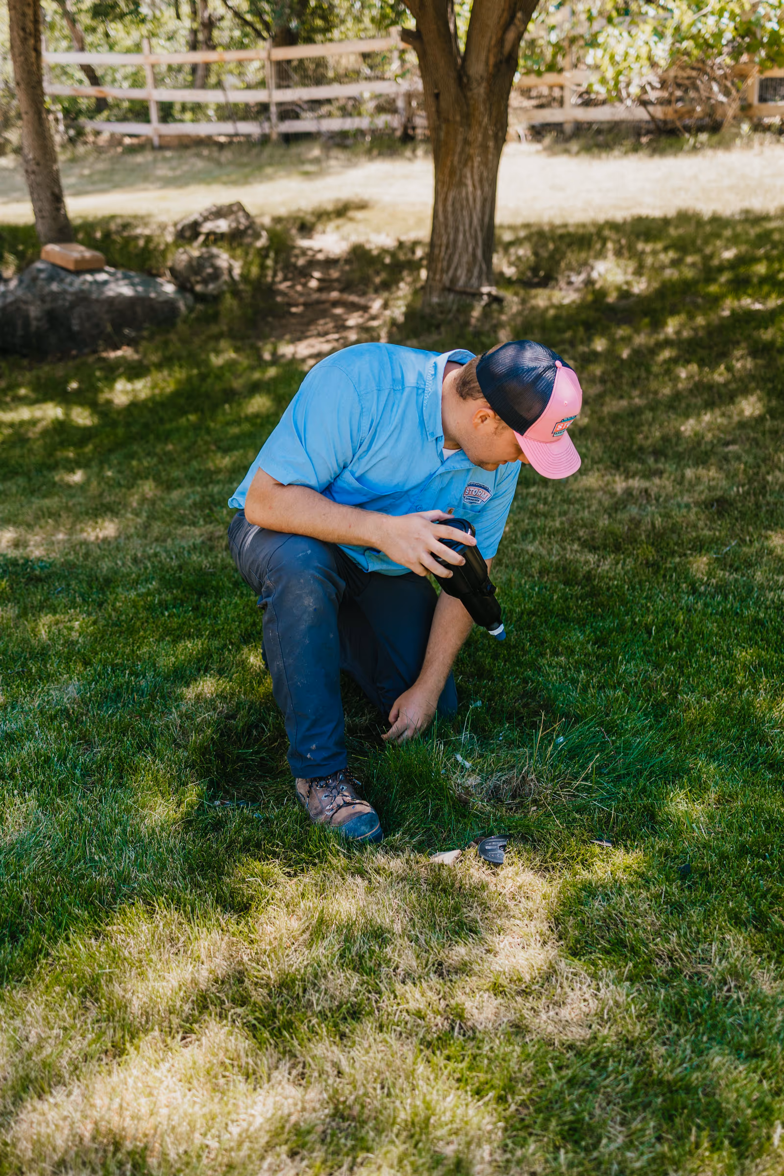 Storm Sprinklers commercial irrigation technician installing a sprinkler head on a Utah property